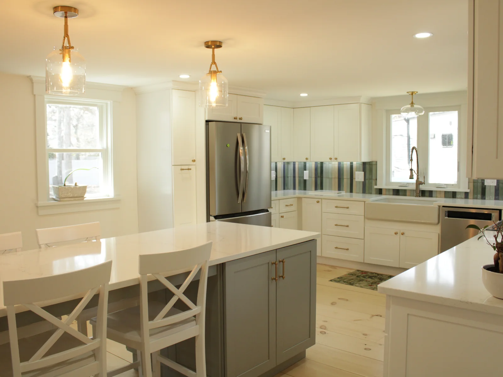 Bright kitchen with island seating and stainless refrigerator