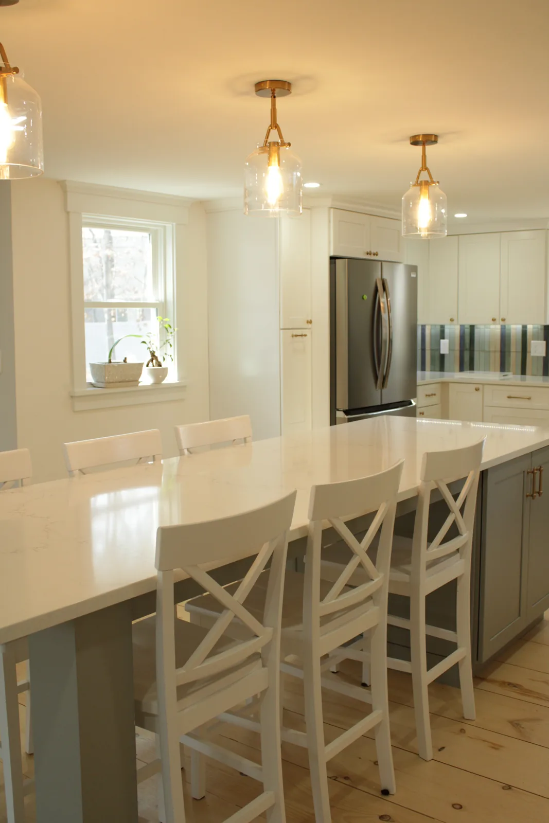 Kitchen remodel with center island, counter stools and pendant lighting