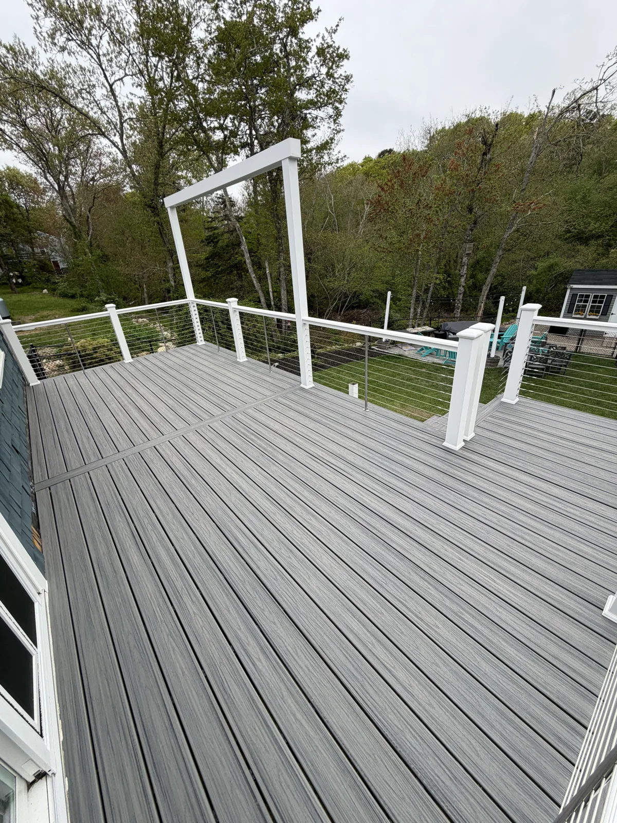 Composite deck boards with white railing and new stairs