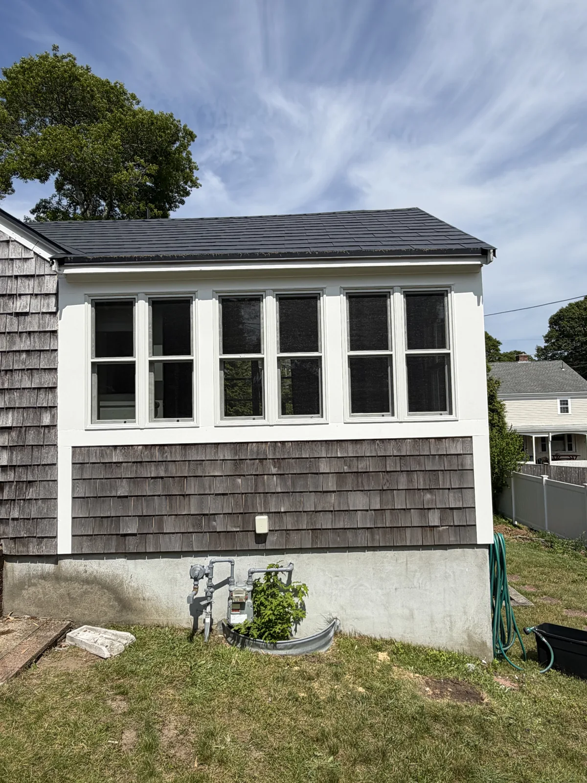 New windows set into fresh shingle siding