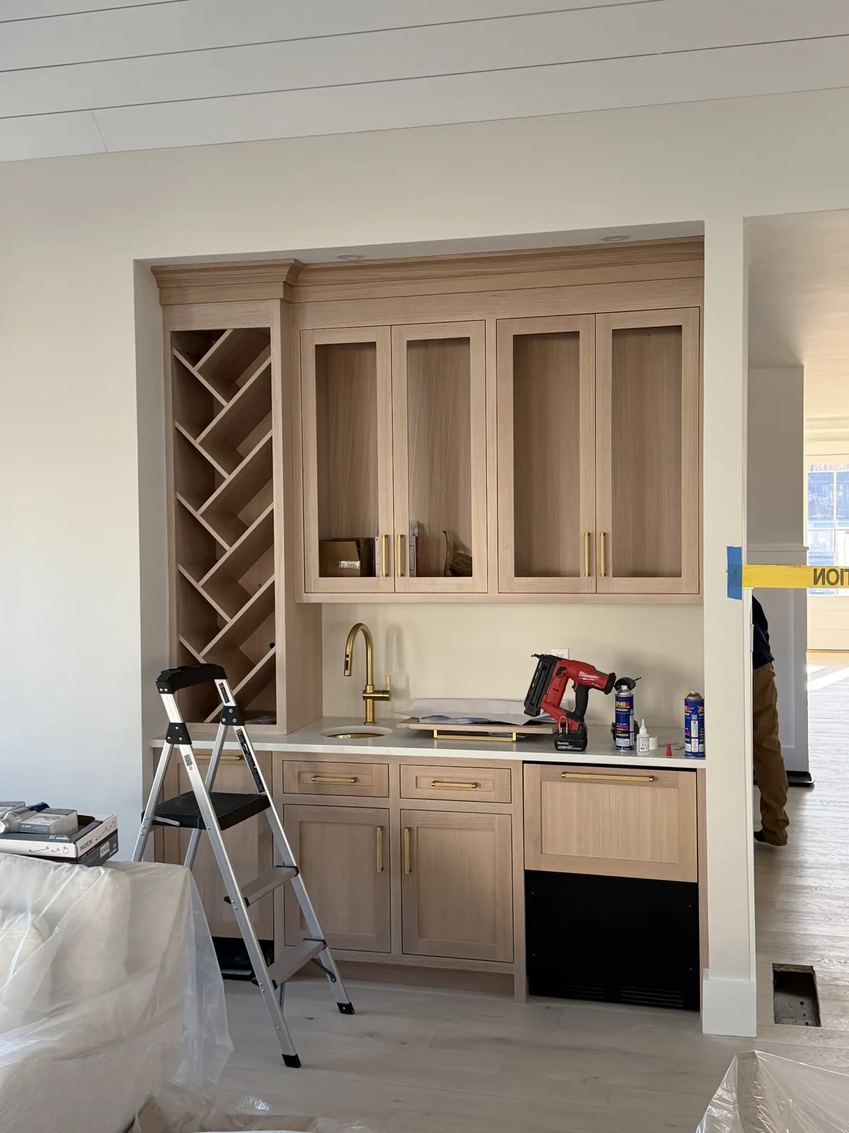 Custom bar cabinetry with wine rack under construction