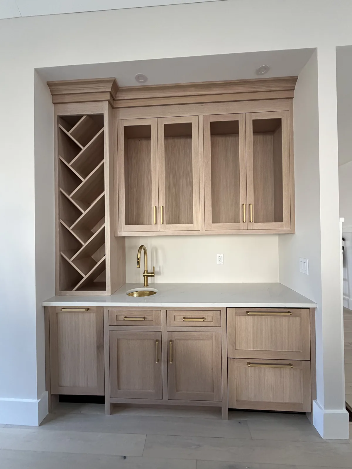 Butler pantry with custom cabinetry, wine storage and counter