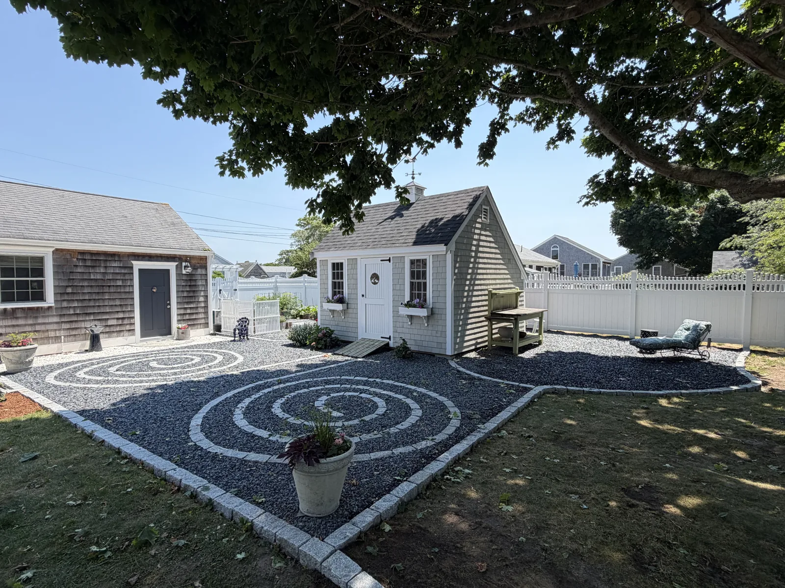 Backyard with circular stone patio and finished outbuilding