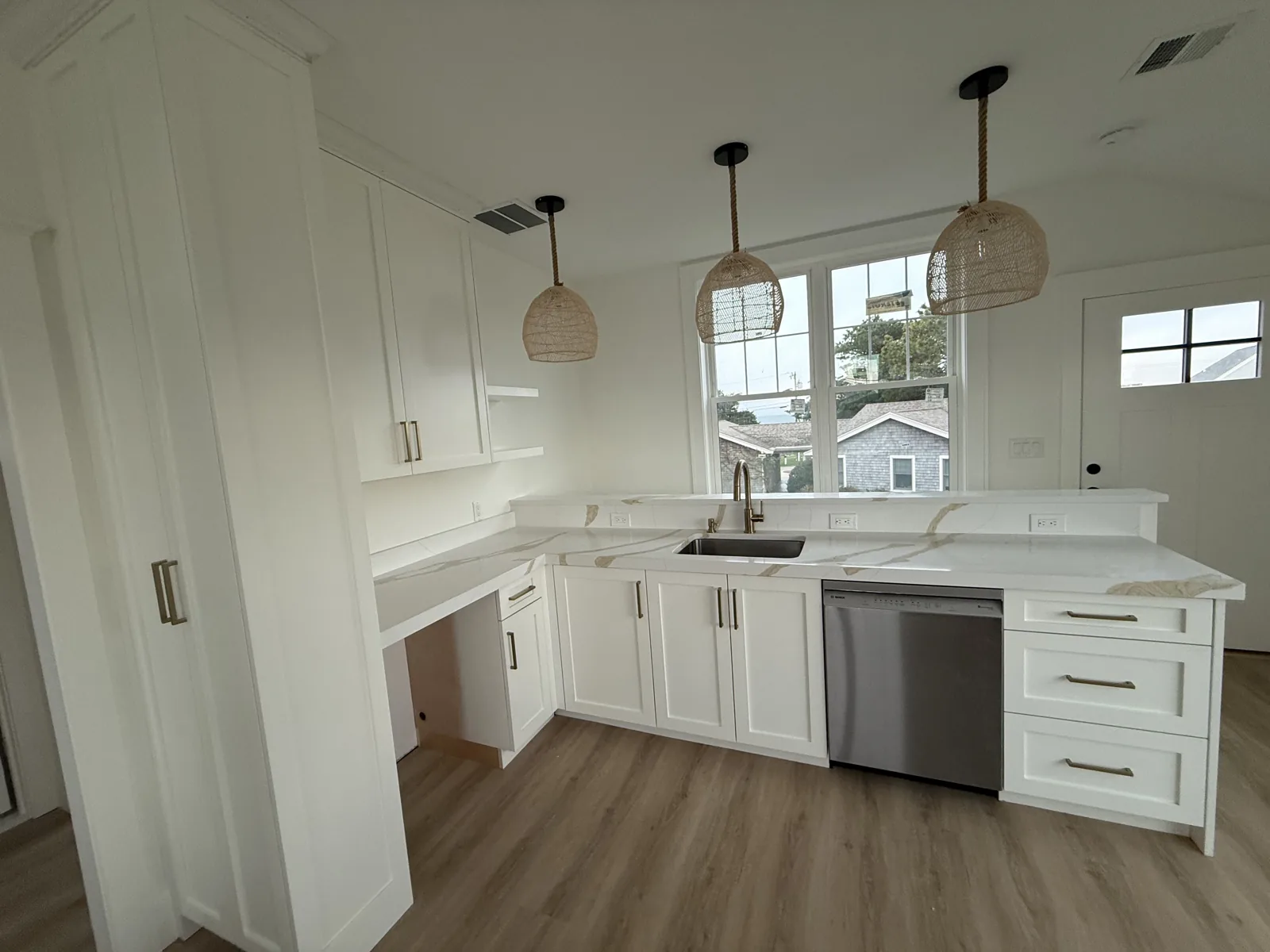 Compact kitchen remodel with white cabinets and quartz counters