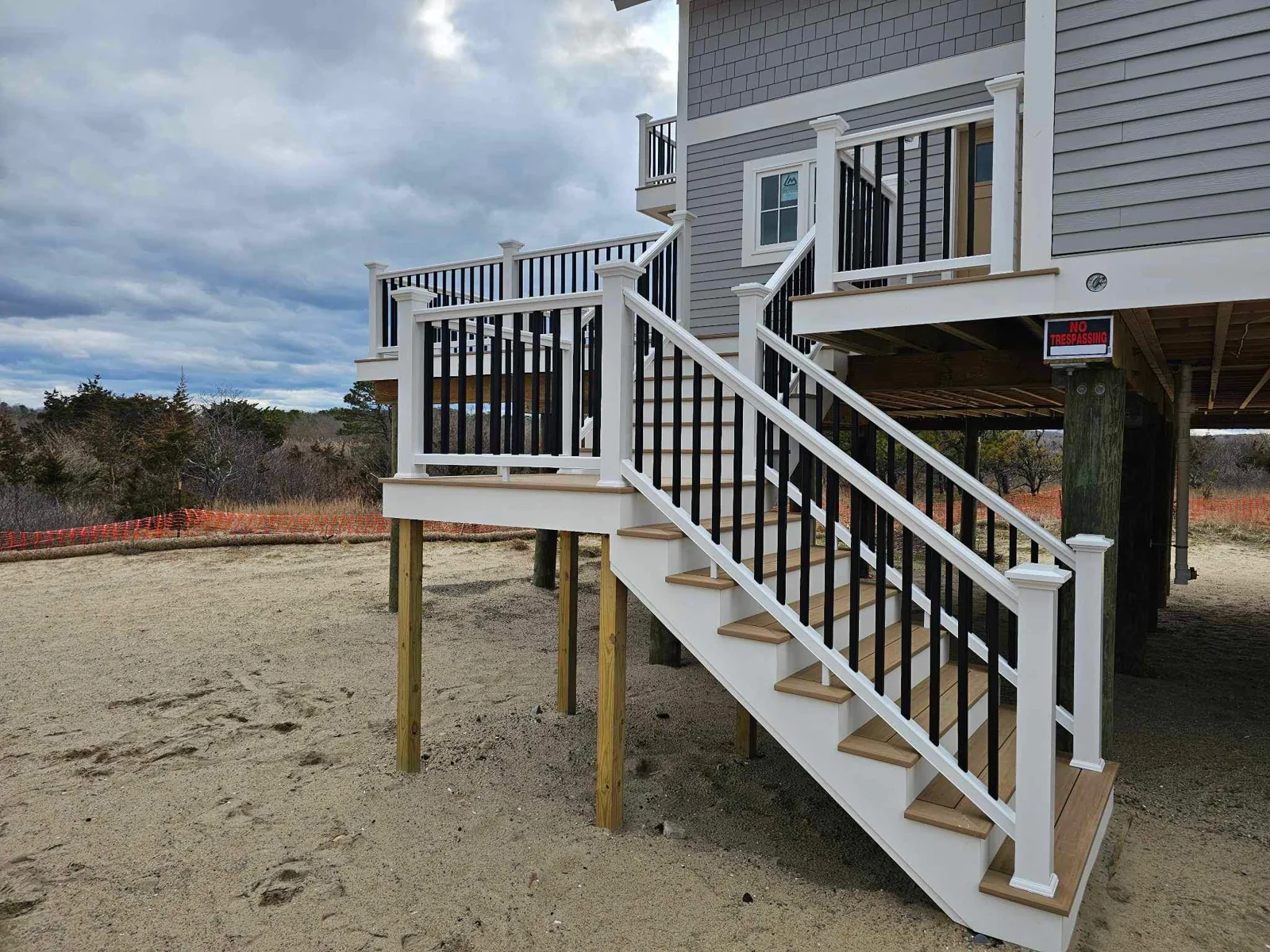 Exterior stairway with white railings at a beachfront home
