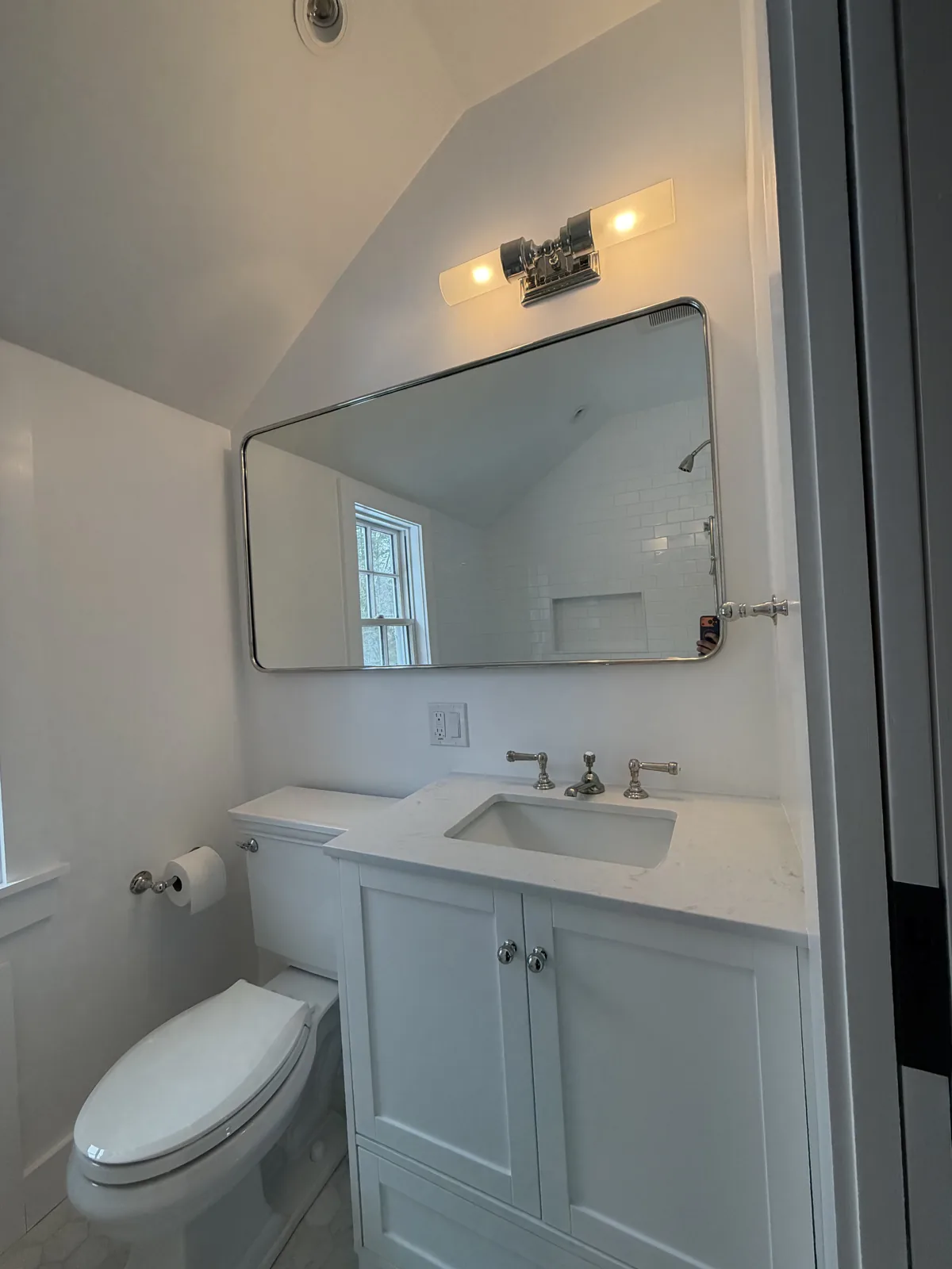 Bathroom vanity with framed mirror and modern fixtures