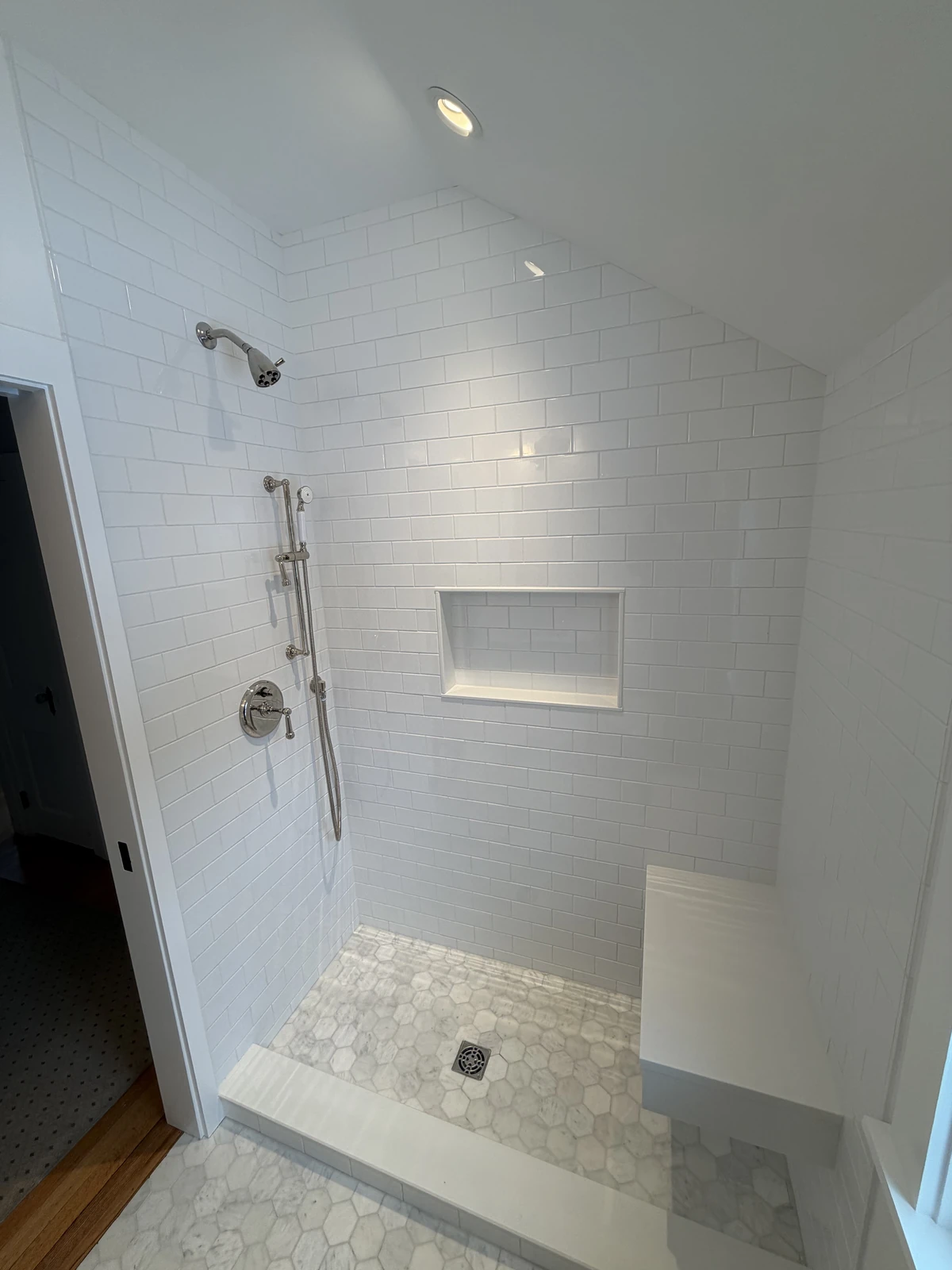 Walk-in shower under a sloped ceiling
