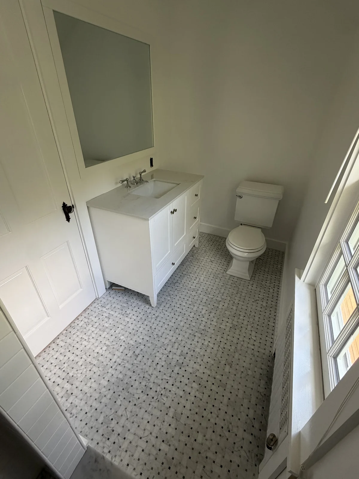 Marble basketweave tile floor in a remodeled bathroom