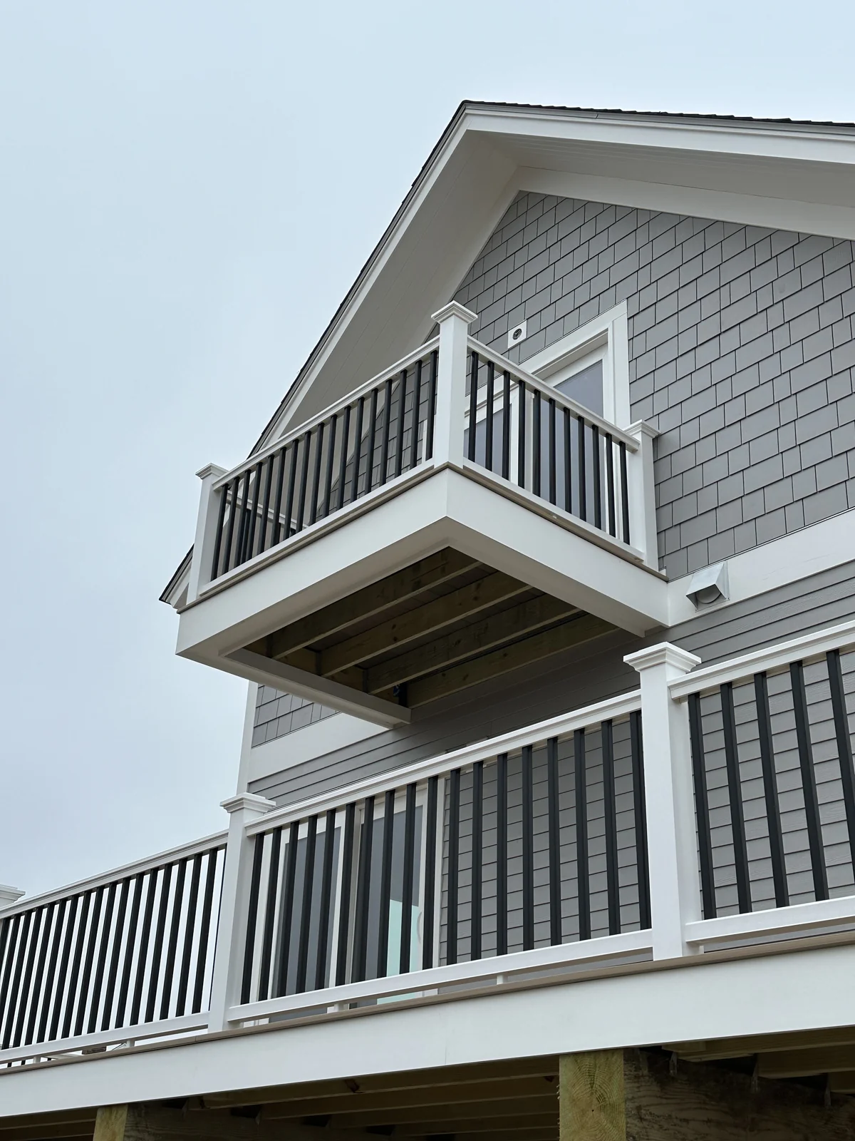 Second story balcony with black balusters