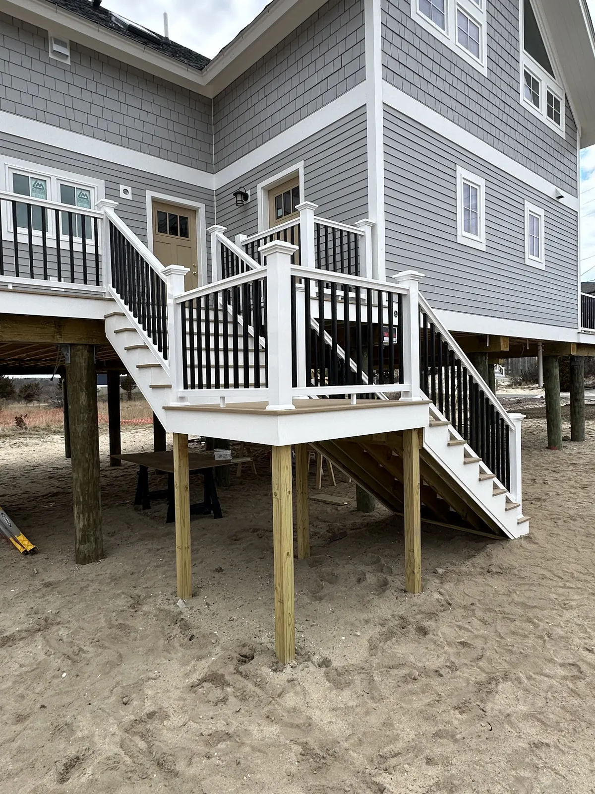 Deck stairs framed under an elevated home