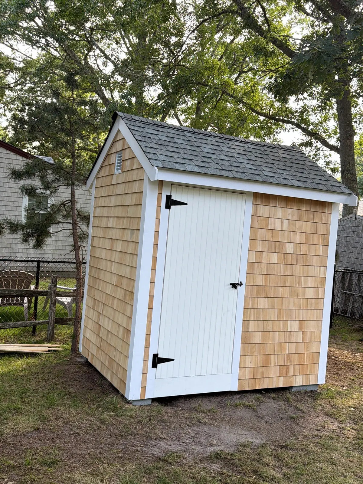Cedar shingle shed with a custom door