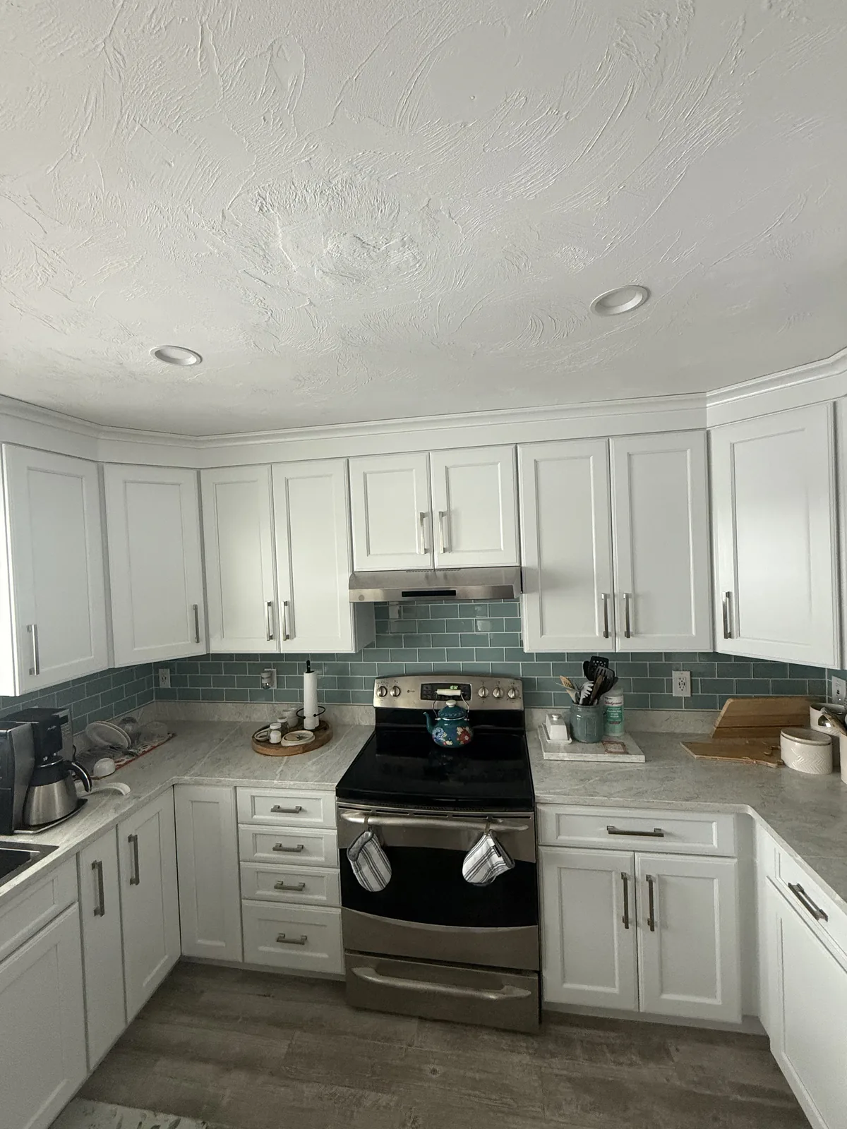White cabinets with a glass tile backsplash