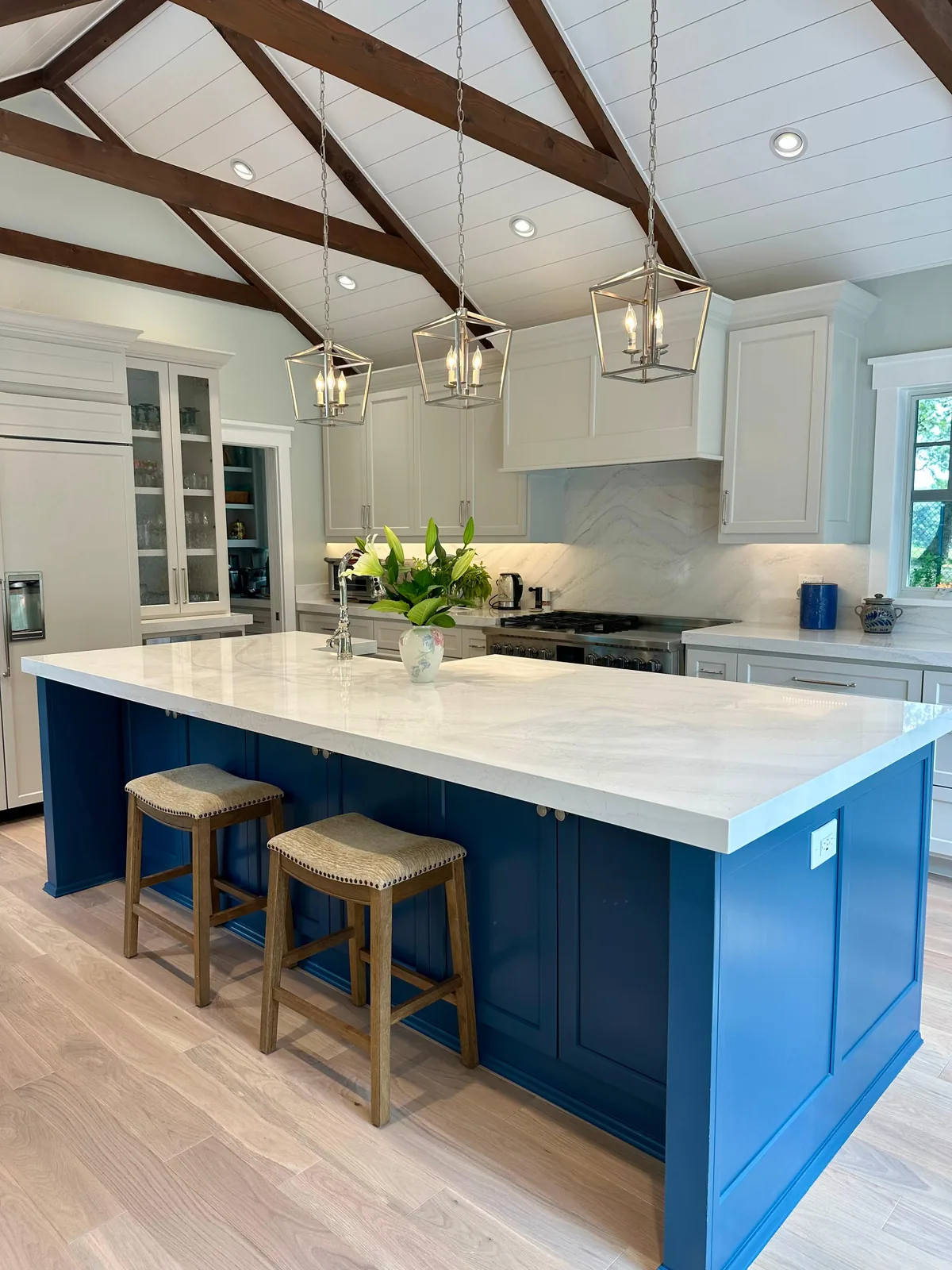 Navy island under a vaulted beamed ceiling