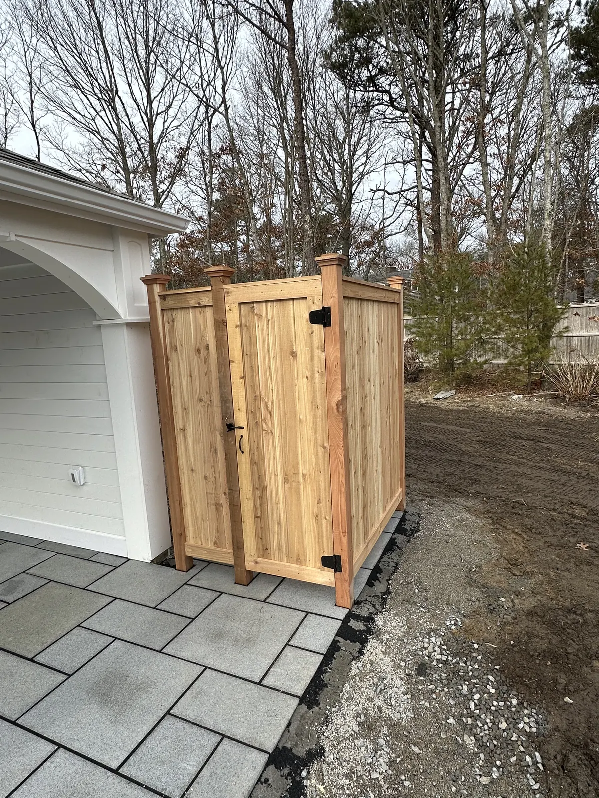 Freestanding cedar shower off the back of the house